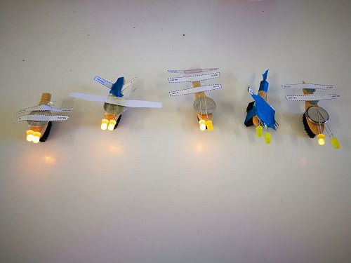 Buzz planes, constructed from paper, batteries, tape, LED lights and toothbrushes!