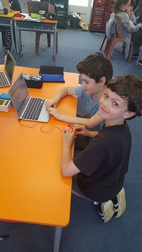 Vincent and Jacob coding Edison to play music, move faster and do both at the same time! Brain power required!