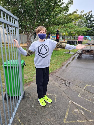 Kingston demonstrates kindness by holding the gate open for others.