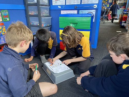 A group playing a multiplication dice game