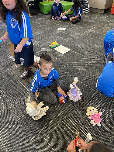 Allazay is enjoying playing with a variety of dolls.