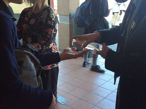 Hands being sanitized after each students has voted
