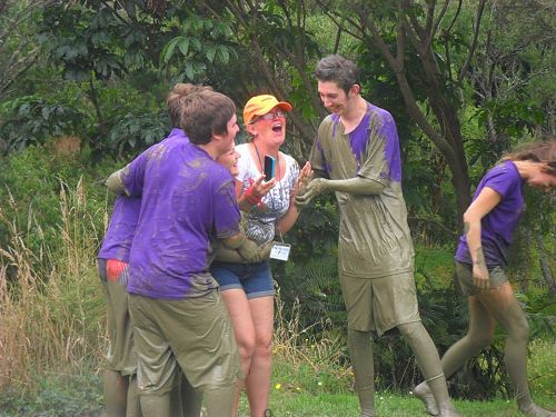 Belinda getting a hug from some rather muddy campers.