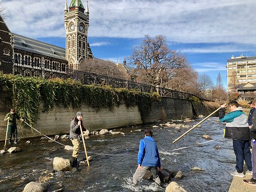 Ben Wilden, Hunter Jolly and Harvey Brenssell beside the University clock tower