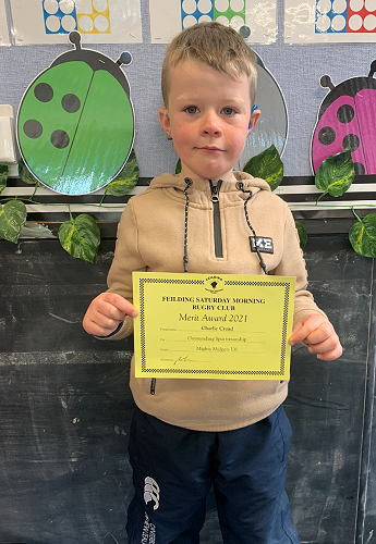 Charlie Croad receiving a reward for putting in a great effort at rugby