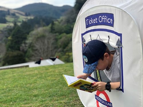 Carson Box enjoying reading in the ticket stand
