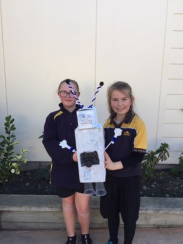 Macy and Mia with their robot, Snowflake.