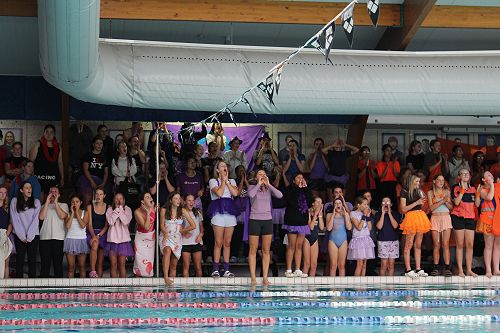 Cheering on Claver junior swimmers