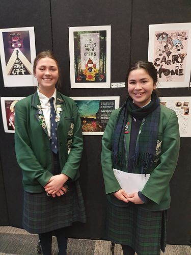 Our Scholarship winners Amaya Leslie and Amelia Chang next to their winning Designs.