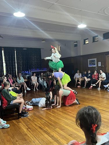 The year 8 dance crew with Jade on top of the pyramid