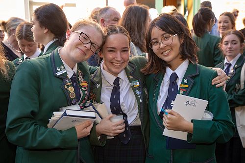 Rosie Davison, Melissa Van der Haegen and Eri Lovegrove celebrate following Leavers' Service