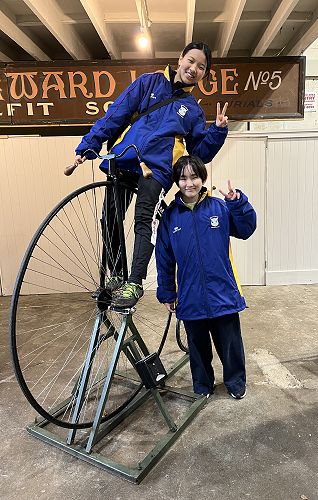 Kyoko and Karea riding the penny farthing in Oamaru