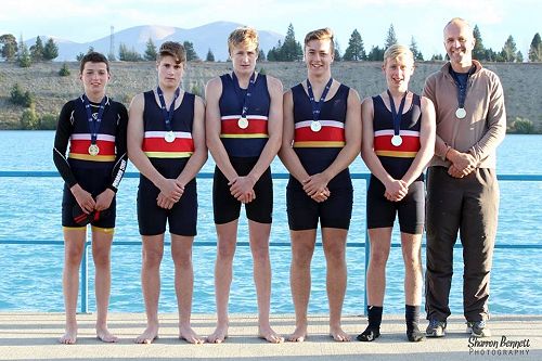 The U16 coxed quad receiving their gold medal