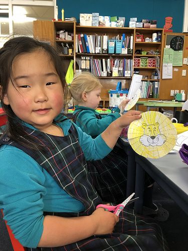 Suzie and Hazel develop fine motor skills as they create a 'Lazy Lion' at Ako Stations.