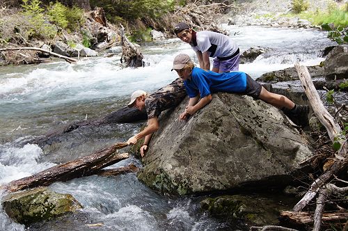 Gabe, Billy and Ben playing 'pooh sticks' at lunchtime
