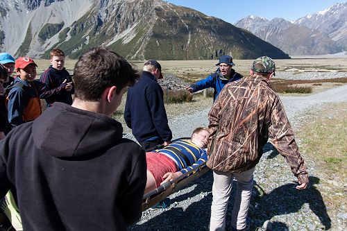 Sam Engelbrecht is carried in a SAR exercise by classmates. 