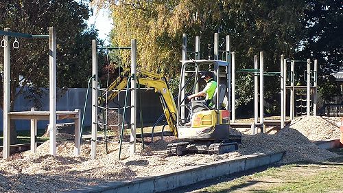 Digger scooping the soft fall