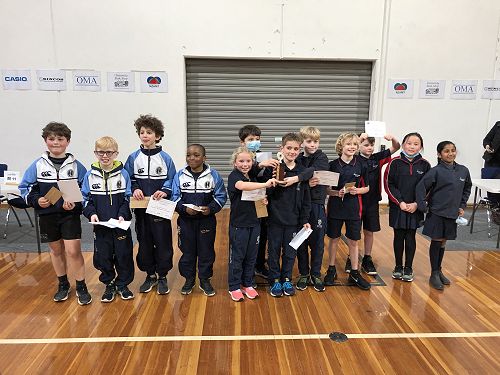 The team accepting their trophy and certificates