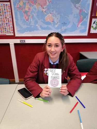 Keita creating cards to accompany the Chemocare bags