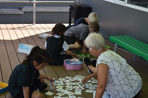 Students enjoying games with friends and grandparents