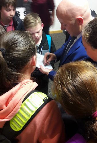 Waimakariri MP Matt Doocey signs the school books of students from Casebrook Intermediate.