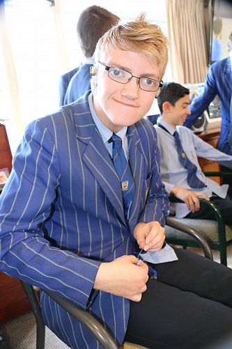 Caleb getting the hang of a needle.