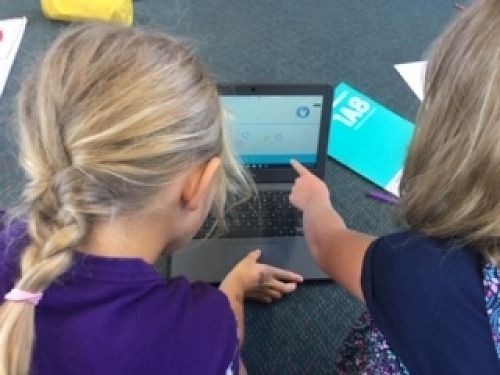 Discussing and deciding on answers to brain maths questions.