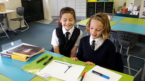 Jasmine Ho and Jasmine Low testing out their drawn code.