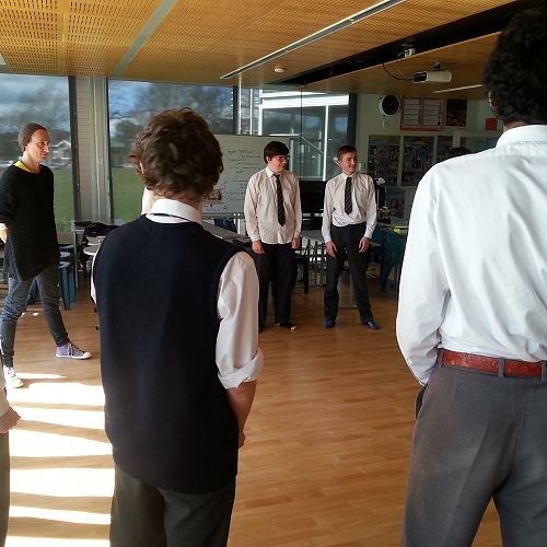 Nick Dunbar, "Hound of the Baskervilles" actor from the Fortune Theatre, joins in on the vocal exercises with the senior drama class