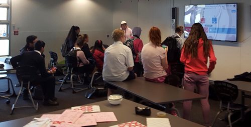 Miss Howie in the library running a lunchtime Kahoot for Pink Shirt Day.