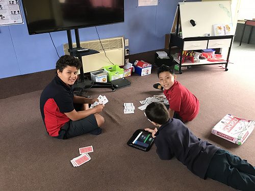 William, Stephen and Liam enjoying card games.