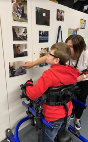 Ellen Entwistle, Specialist Services support person, is walking with Matthew to his assistive technology learning session. Matthew can see things he hasn't noticed before. He found a photo of himself playing a computer game via eye gaze! 