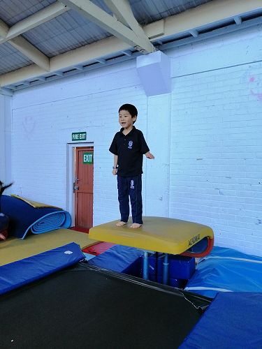 Ricky jumping onto the big trampoline. 