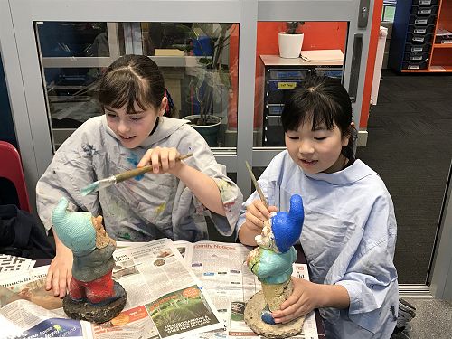 Katie and Anika painting the gnomes