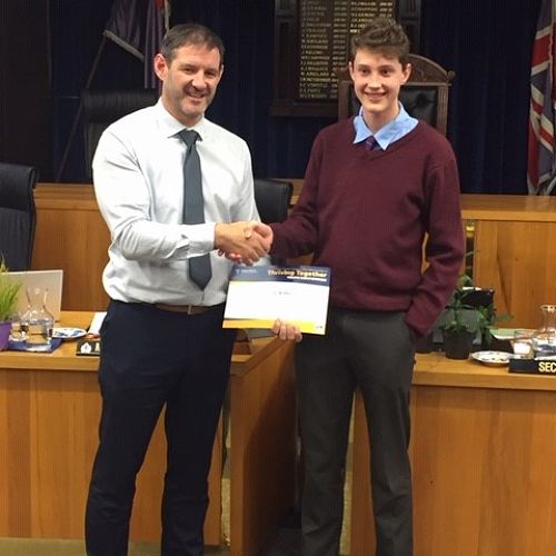 Mayor Bowen presenting Oli with his 2nd place certificate in the 'Thriving Together' competition