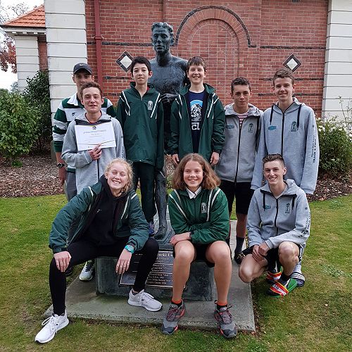 National Cross Country Team Members pictured with the statue of Jack Lovelock outside Timaru Boys High School.
