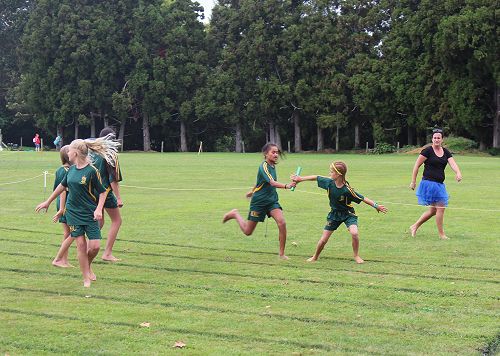 Deizyl Toma hands over the baton to Mackenzie Walter for Year 7 Girls MacMillan in the 4 x 100m relay