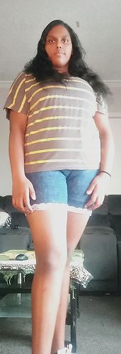 Virangali models her shorts - where she cut the jeans to length, hemmed them and hand sewed lace to add a finishing touch.