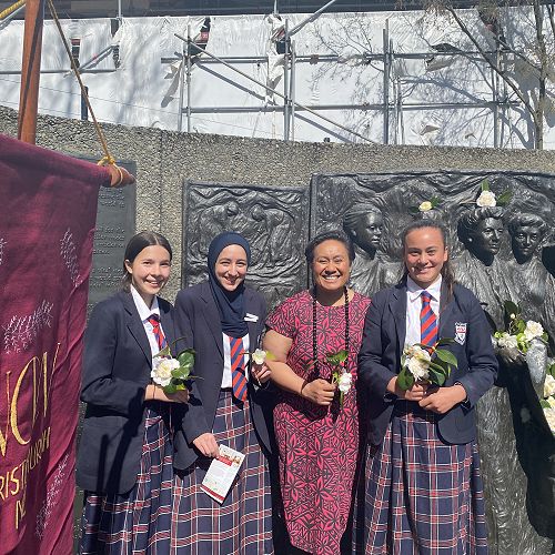 Sufferage Day -  Olivia, Malika and Charlie with Deputy Principal Maria Lemalie in front of the Kate Shepherd Memorial. 