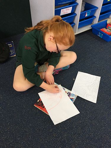 Zoe working on her plan, completing the chalk outline.