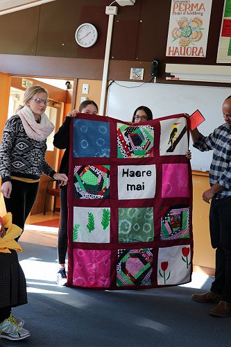 Natasha, Eain-Si, Mia presenting the quilt to Namrud