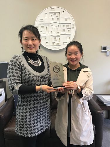 Ms Ding and Miss Jin holding the 2019 Confucius Classroom of the Year trophy