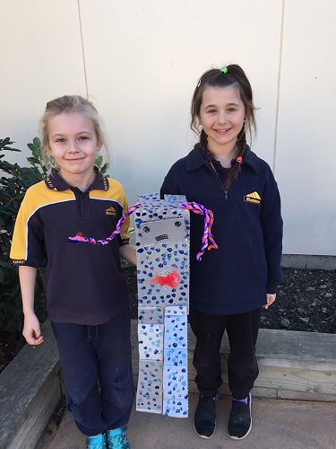 Laci and Briarna and their robot Rosie-Ana.