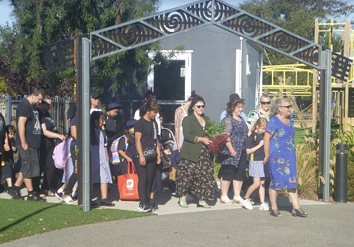 Maire holding the koha (gift) - manuhiri gathering at the waharoa