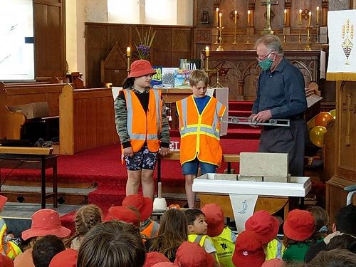 Two school representatives with Warwick Brunton