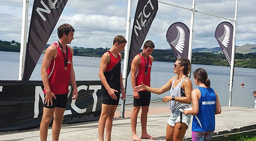 Lisa Carrington presents Dylan Neal-Hill with his medal