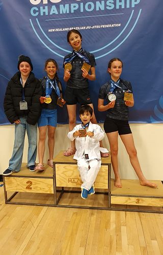 Hannah, her siblings and team mates with medals