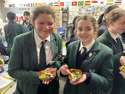 Abigail and Alexis (both from Year 9) sample a Japanese dessert of matcha ice cream, red bean sauce and sesame dango.