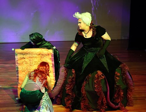 Ariel signs Ursula's contract exchanging her voice for human legs
