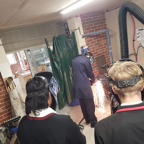 Joel Harris demonstrates plasma cutting.